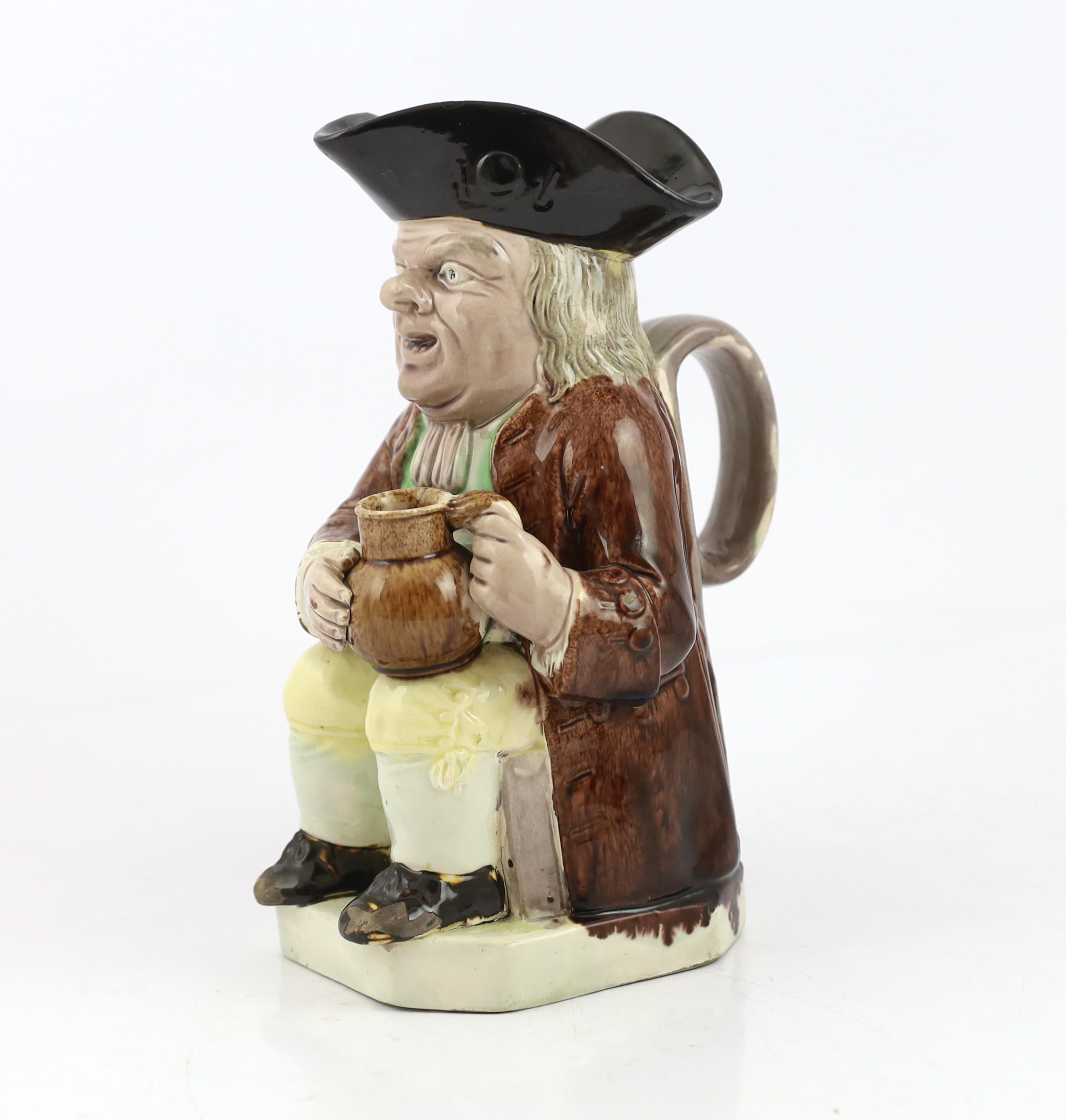 A Ralph Wood type creamware Toby jug of standard type, c.1790, glaze losses and some retouching to the enamels